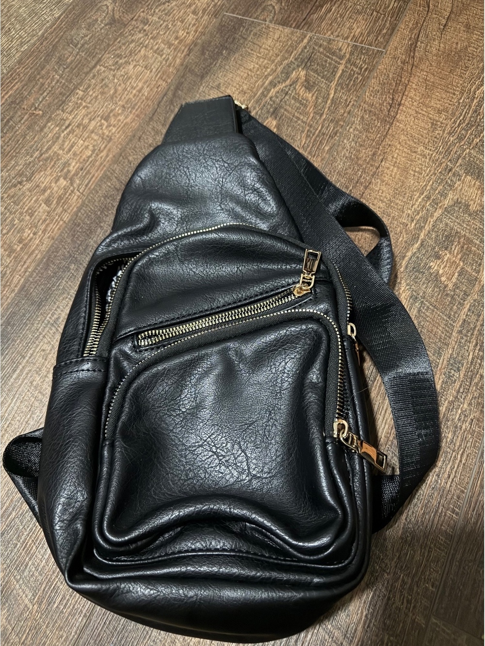 Black Faux Leather Sling Bag with Multiple Zippered Compartments and Adjustable